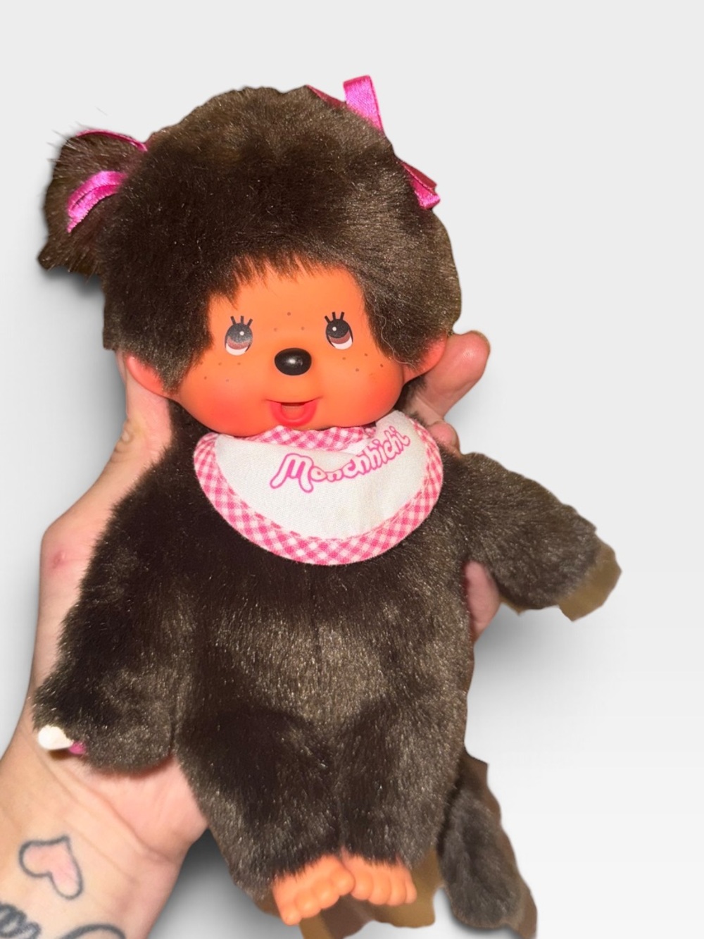 Monchhichi plush with pink white bib